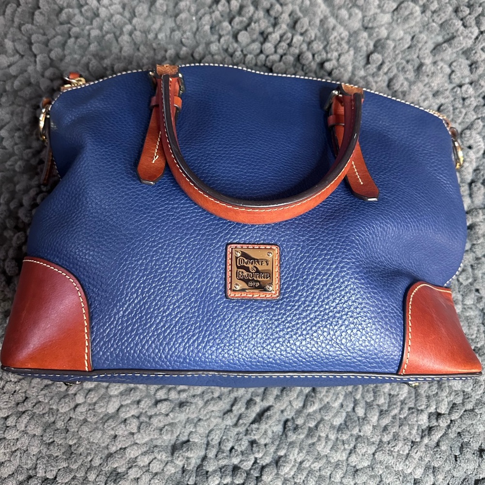 Dooney & Bourke Pebble Grain Domed Satchel in blue leather with tan trim.